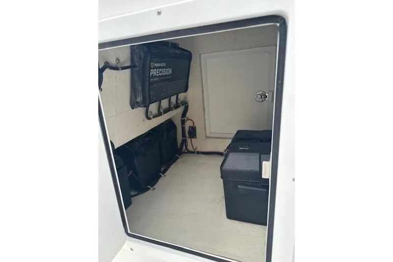 Slide: The Image of 2023 Layton Bay 22 boat storage compartment with battery and equipment. - 12