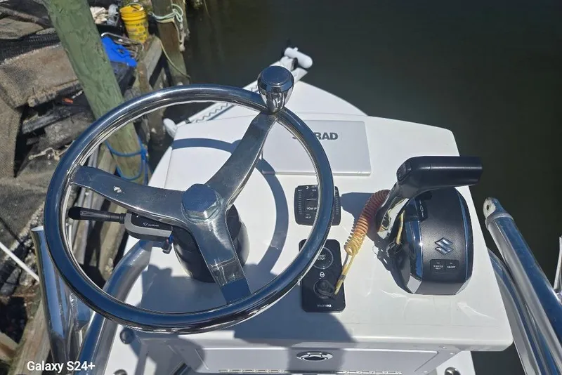 Slide: The Image of Steering console of 2023 Layton Bay 22 boat with controls and steering wheel. - 14