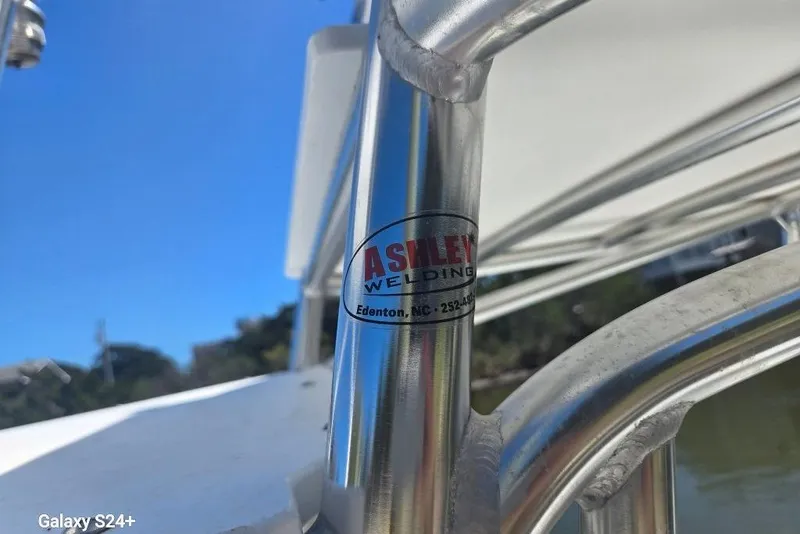 Slide: The Image of Chrome railing on a 2023 Layton Bay 22 boat with Ashley Welding label. - 16