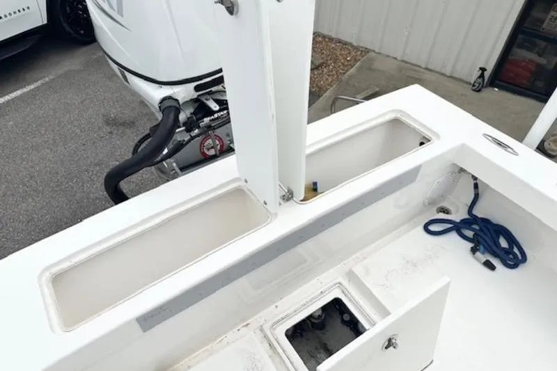 Slide: The Image of 2023 Layton Bay 22 boat deck with storage compartments and outboard motor. - 18