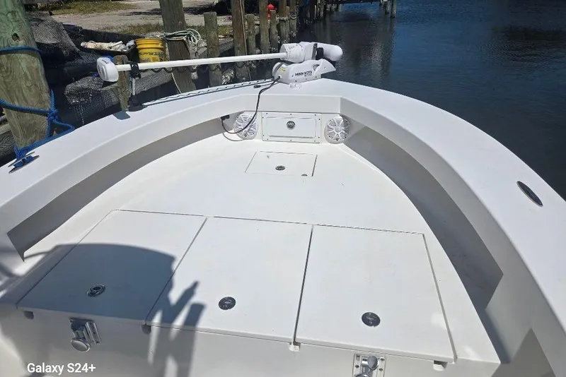 Slide: The Image of 2023 Layton Bay 22 boat deck with storage compartments and trolling motor. - 19
