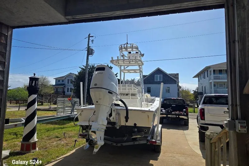 Slide: The Image of 2023 Layton Bay 22 boat on trailer in residential driveway, sunny day. - 4