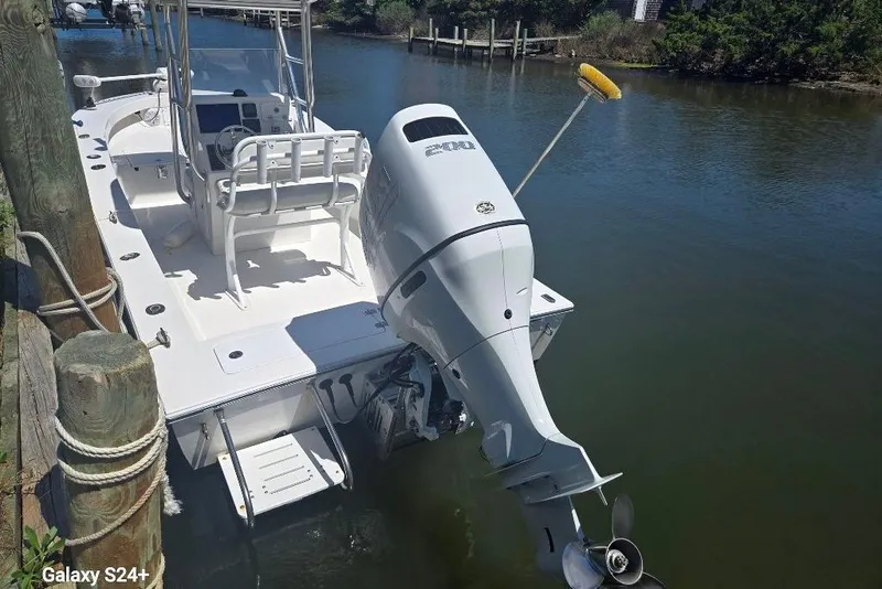 Slide: The Image of 2023 Layton Bay 22 boat docked with powerful outboard motor. - 8