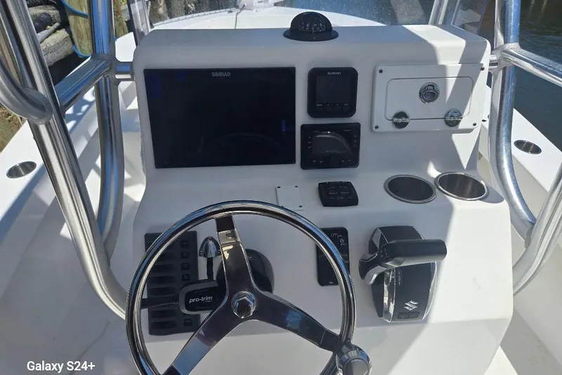 Slide: The Image of 2023 Layton Bay 22 boat console with steering wheel and navigation controls. - 9