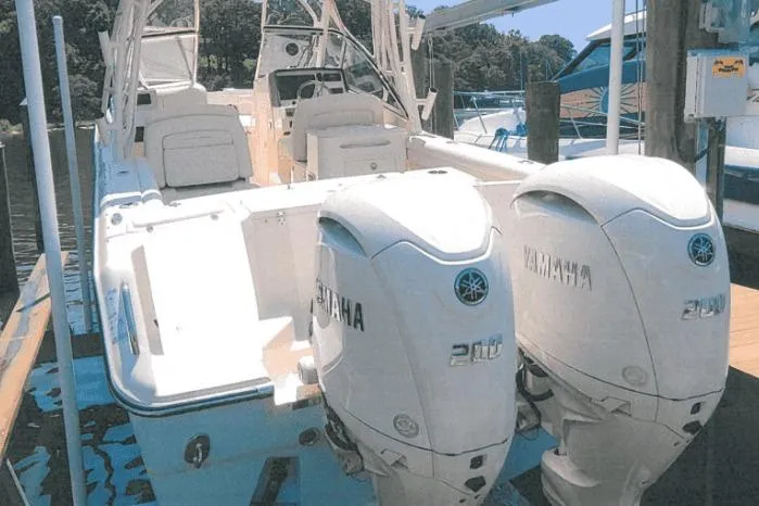 The Image of 2025 Grady-White Freedom 275 boat with twin Yamaha engines docked at marina. - 0