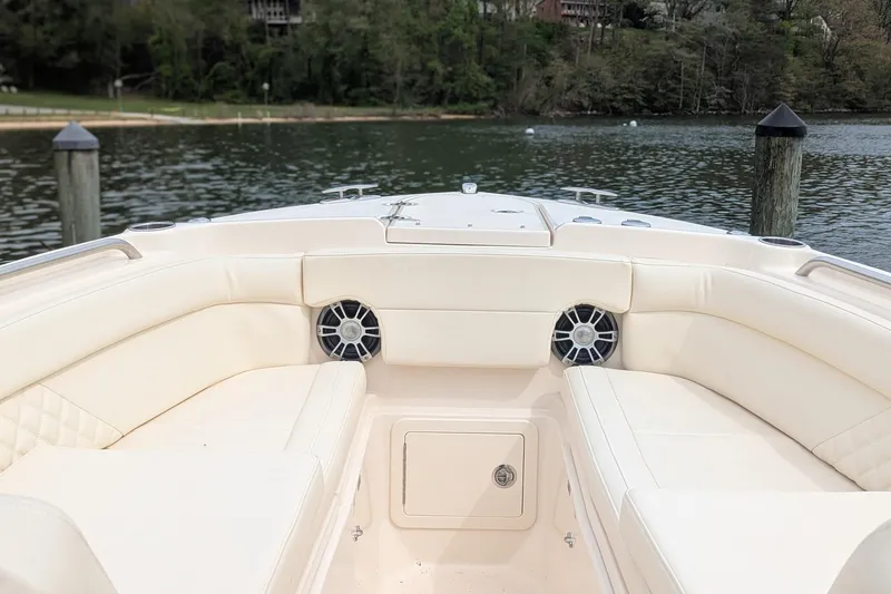 Slide: The Image of 2025 Grady-White Freedom 275 boat interior with compact marine toilet and wooden flooring. - 11