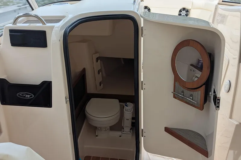 Slide: The Image of Anchor compartment of 2025 Grady-White Freedom 275 boat, featuring stainless steel fittings. - 14