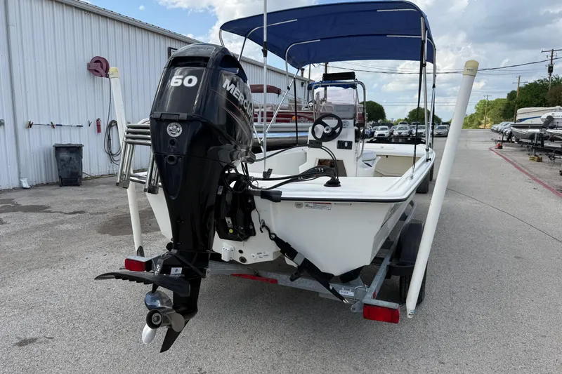 Slide: The Image of 2018 Mako Pro Skiff 17 CC with Mercury 60 outboard motor, parked outdoors. - 11