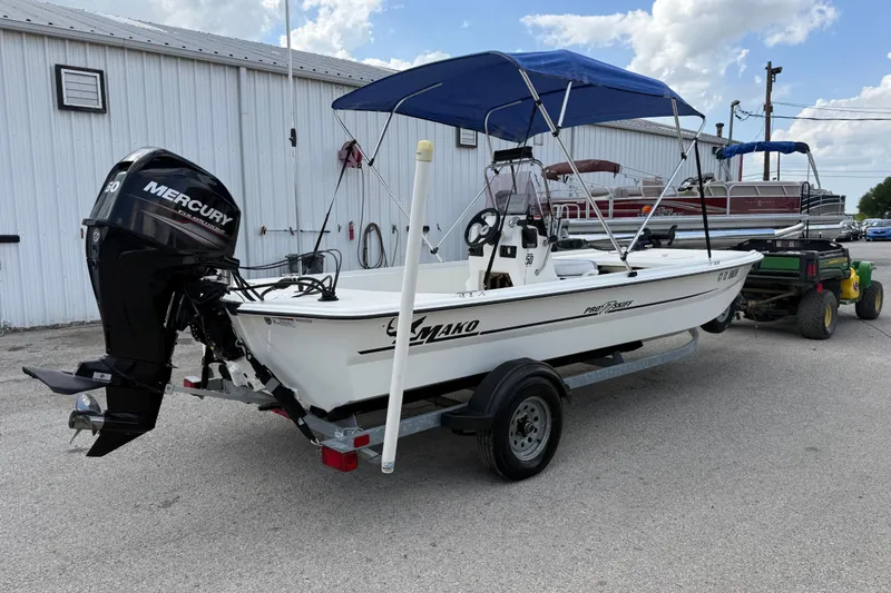 Slide: The Image of 2018 Mako Pro Skiff 17 CC boat with Mercury engine on trailer, parked outdoors. - 12