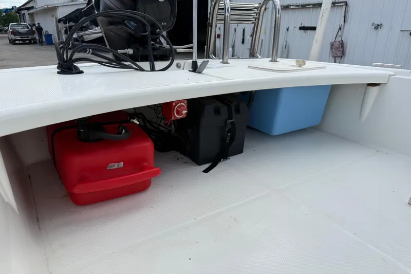 Slide: The Image of 2018 Mako Pro Skiff 17 CC boat interior with storage compartments and equipment. - 23