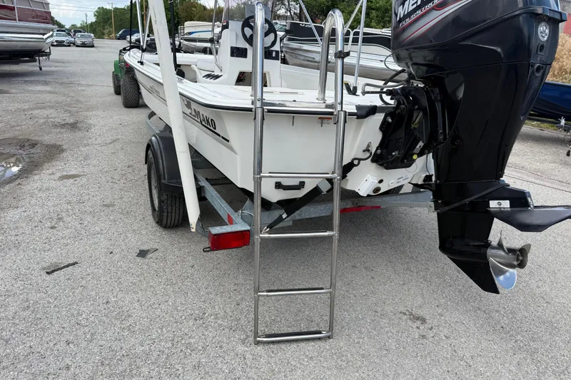 Slide: The Image of 2018 Mako Pro Skiff 17 CC boat on trailer with outboard motor and ladder. - 25