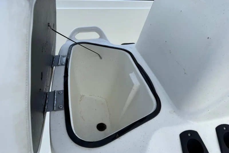 Slide: The Image of Open storage compartment on a 2018 Mako Pro Skiff 17 CC boat. - 27