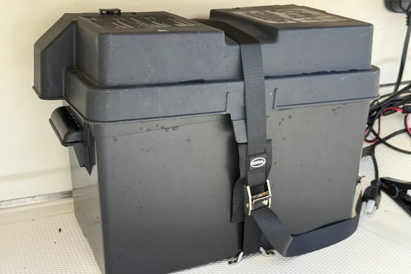 Slide: The Image of Black battery box secured with a strap on a 2018 Mako Pro Skiff 17 CC boat. - 29