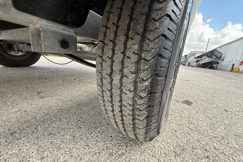 Slide: The Image of Close-up of a trailer tire for a 2018 Mako Pro Skiff 17 CC boat. - 37