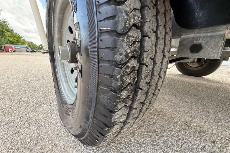 Slide: The Image of Close-up of a 2018 Mako Pro Skiff 17 CC trailer tire on asphalt. - 38