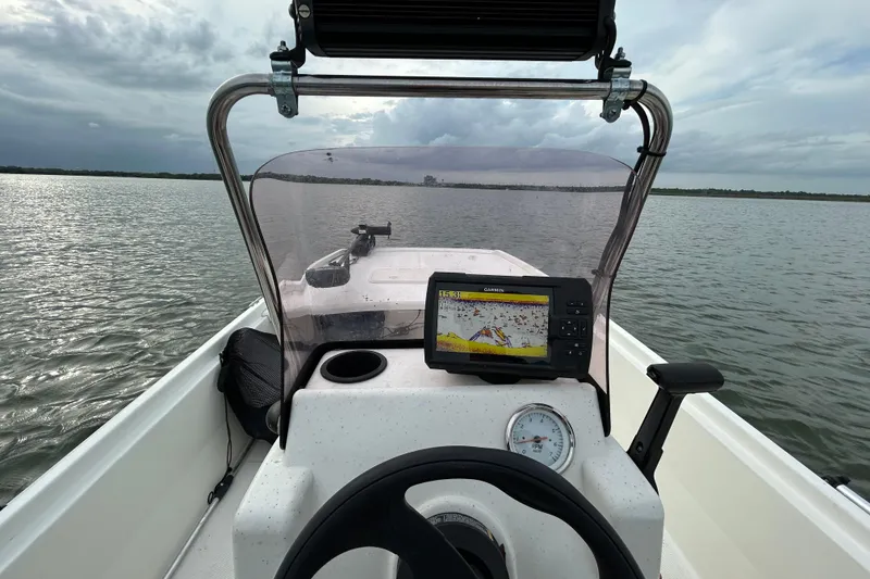 Slide: The Image of 2018 Mako Pro Skiff 17 CC dashboard with GPS on calm waters. - 41