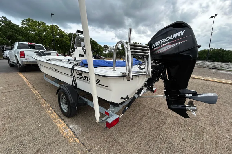 Slide: The Image of 2018 Mako Pro Skiff 17 CC boat on trailer with Mercury outboard motor. - 49