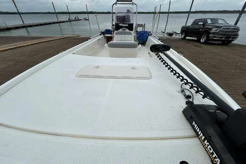 Slide: The Image of 2018 Mako Pro Skiff 17 CC boat at dock with Minn Kota motor. - 51