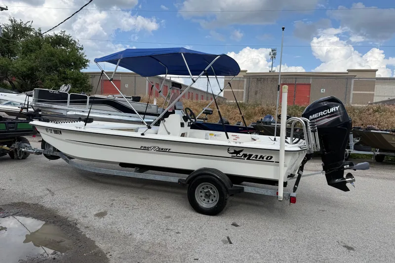 Slide: The Image of 2018 Mako Pro Skiff 17 CC boat with Mercury outboard motor and blue canopy. - 7