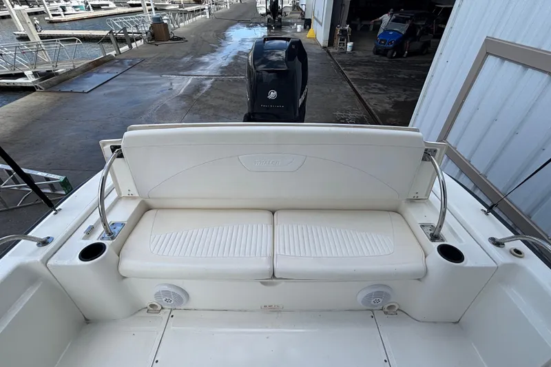Slide: The Image of 2005 Boston Whaler 220 Dauntless boat interior with cushioned seating and cup holders. - 10
