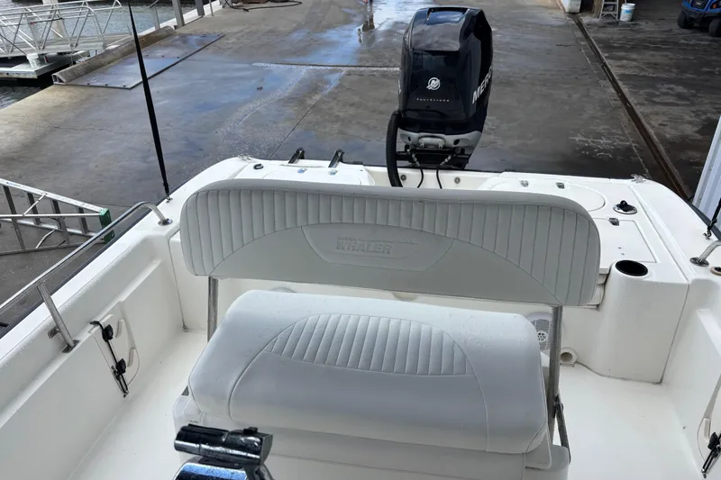 Slide: The Image of 2005 Boston Whaler 220 Dauntless boat interior with seating and Mercury outboard motor. - 16