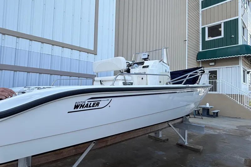 Slide: The Image of 2005 Boston Whaler 220 Dauntless boat on display outside a building. - 18