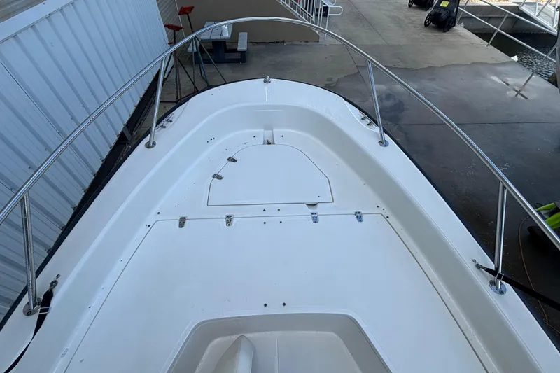 Slide: The Image of 2005 Boston Whaler 220 Dauntless boat deck with stainless steel railings. - 8
