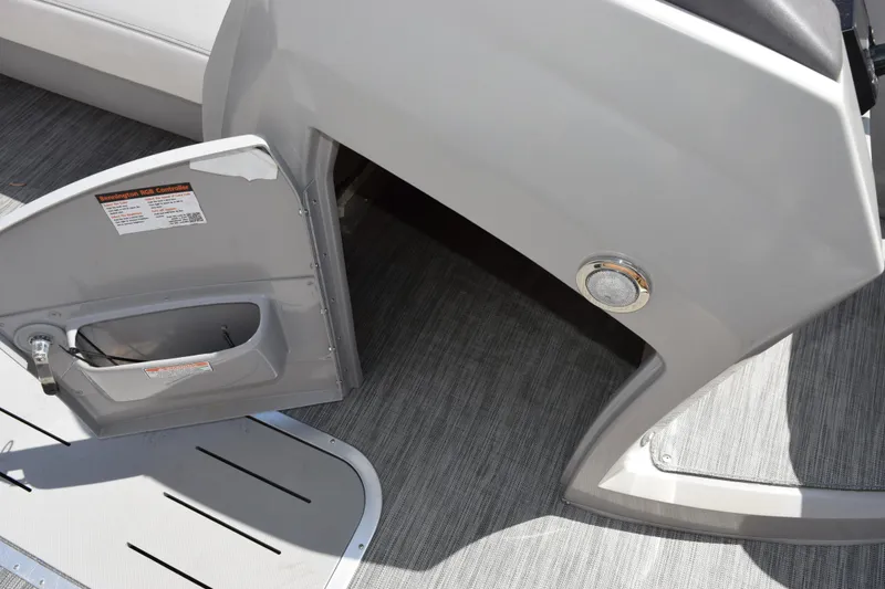 Slide: The Image of Open compartment door on 2021 Bennington L 23 Swingback boat interior. - 14
