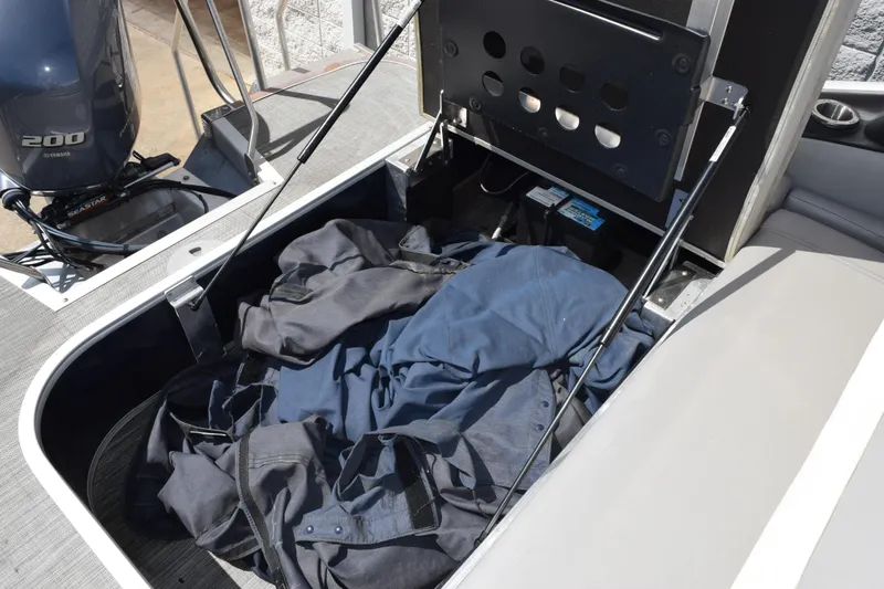 Slide: The Image of Open storage compartment on 2021 Bennington L 23 Swingback boat with Yamaha 200 engine. - 16