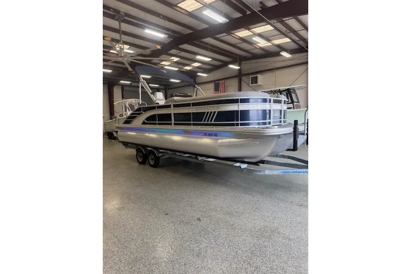 Slide: The Image of 2021 Bennington L 23 Swingback pontoon boat in indoor showroom. - 20
