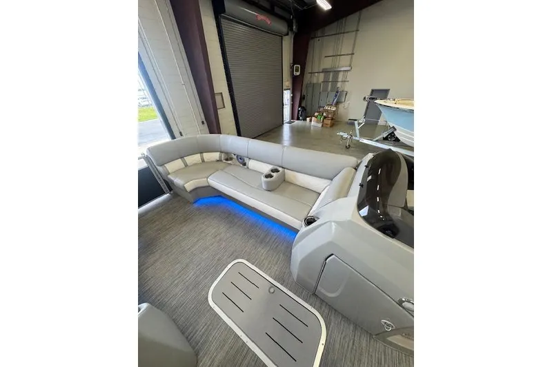 Slide: The Image of 2021 Bennington L 23 Swingback pontoon boat interior with modern seating and ambient lighting. - 26