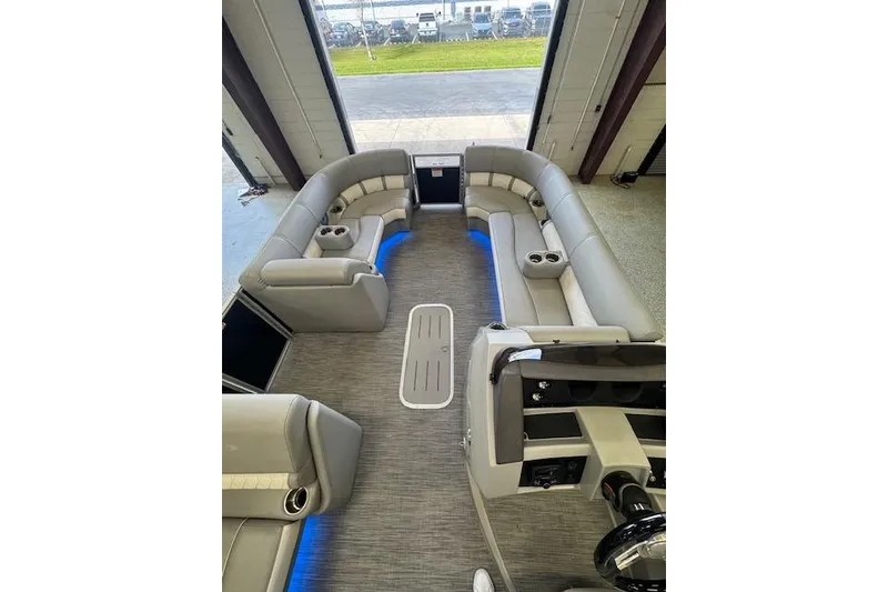 Slide: The Image of 2021 Bennington L 23 Swingback interior with plush seating and ambient lighting. - 27