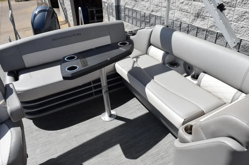 Slide: The Image of Luxurious seating area on 2021 Bennington L 23 Swingback pontoon boat with table and cup holders. - 7