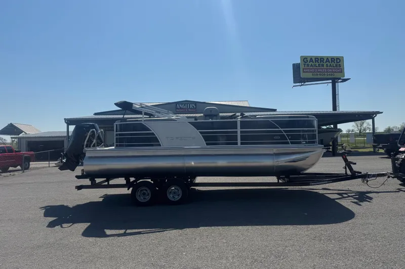 The Image of 2026 Trifecta 22RFCS3 pontoon boat on trailer at dealership. - 1