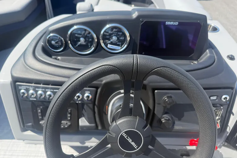 Slide: The Image of Steering console of 2026 Trifecta 22RFCS3 boat with gauges and Simrad display. - 10