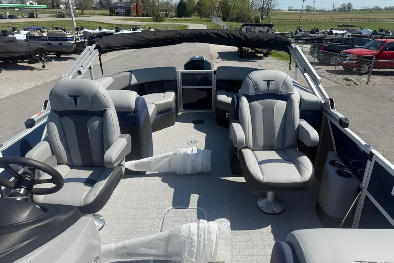 Slide: The Image of 2026 Trifecta 22RFCS3 pontoon boat interior with plush seating and steering wheel. - 14