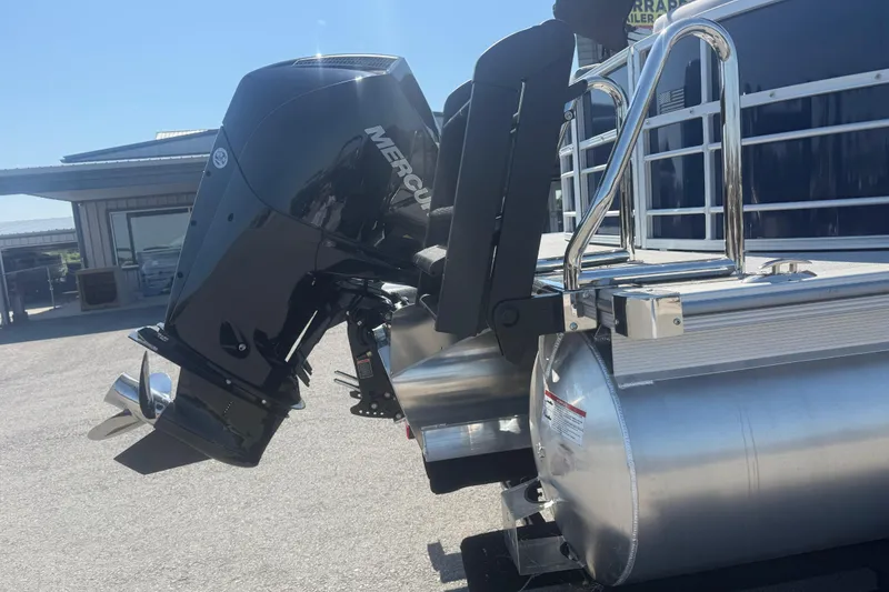 Slide: The Image of 2026 Trifecta 22RFCS3 pontoon boat with Mercury outboard motor, parked outdoors. - 8