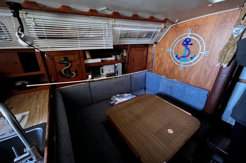 Slide: The Image of Cozy interior of 1985 Catalina 36 MkII sailboat with nautical decor and seating area. - 3