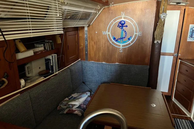Slide: The Image of Interior of 1985 Catalina 36 MkII sailboat with cozy seating and nautical decor. - 4