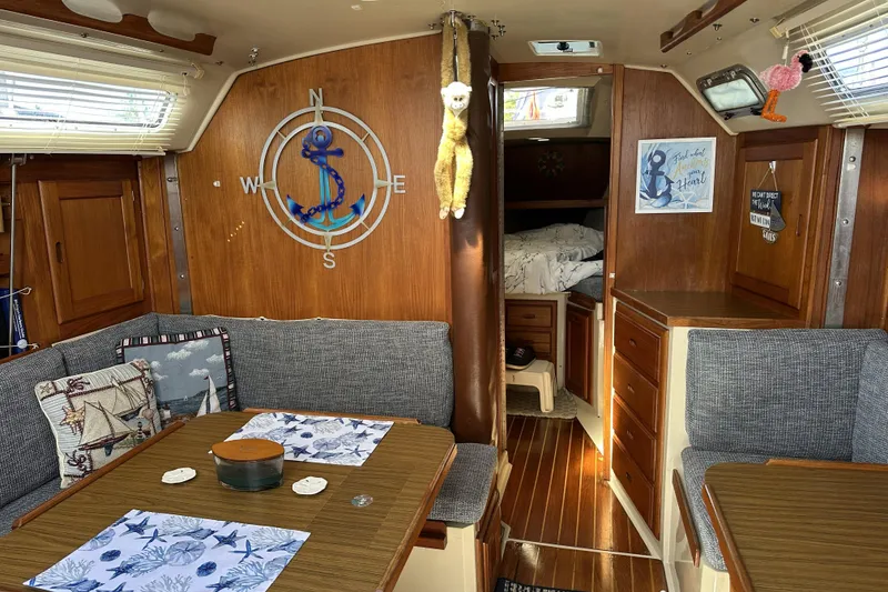 Slide: The Image of Interior of a 1985 Catalina 36 MkII sailboat with nautical decor and cozy seating. - 15