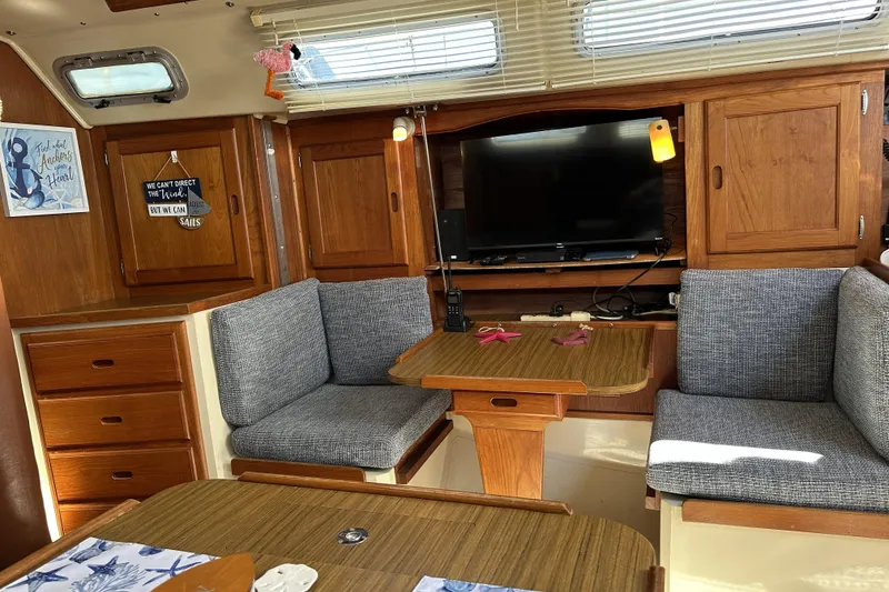 Slide: The Image of Interior of 1985 Catalina 36 MkII sailboat with cozy seating and wooden cabinetry. - 13