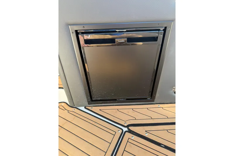 Slide: The Image of Built-in refrigerator on 2019 Rinker EX 320 boat with teak flooring. - 15