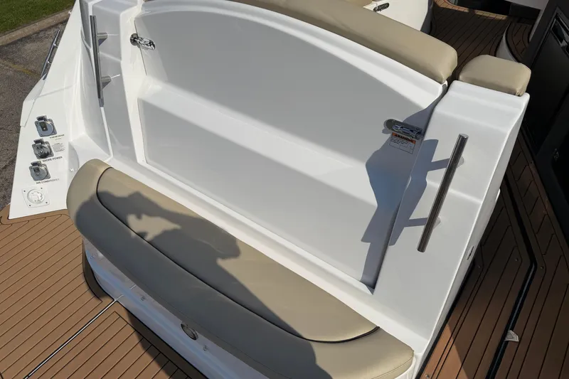 Slide: The Image of 2019 Rinker EX 320 boat interior with beige seating and control panel. - 2