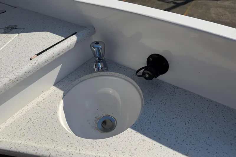 Slide: The Image of 2019 Rinker EX 320 boat sink with faucet and countertop detail. - 20