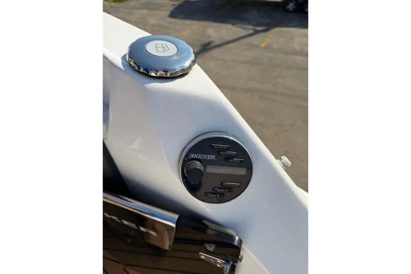 Slide: The Image of 2019 Rinker EX 320 boat dashboard with Kicker audio controls and fuel cap. - 21