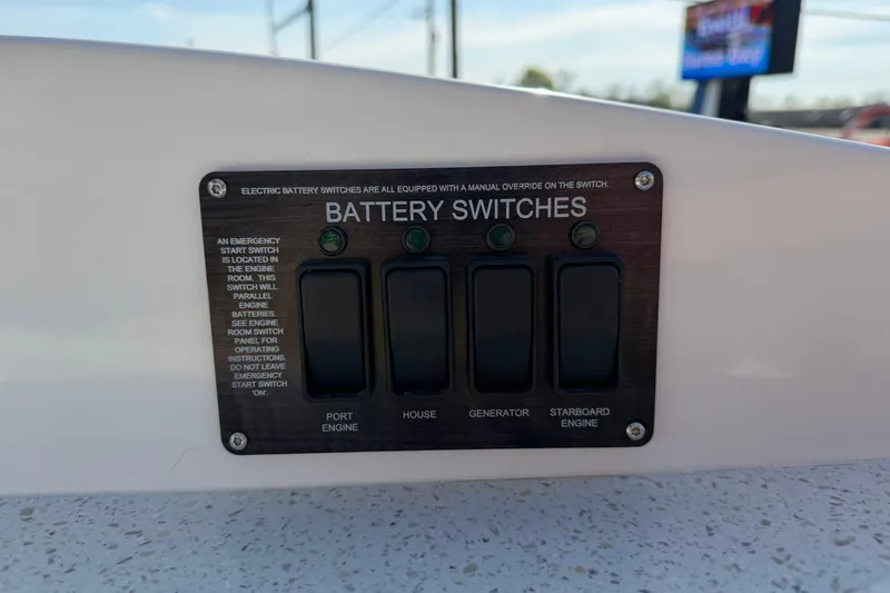 Slide: The Image of Battery switches panel on 2019 Rinker EX 320 boat, featuring port, house, generator, and starboard controls. - 22