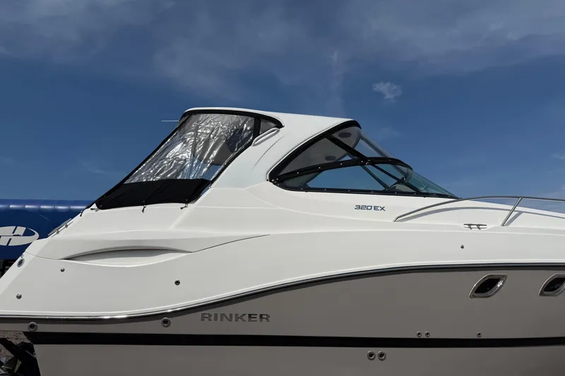 Slide: The Image of 2019 Rinker EX 320 boat deck with open hatch and railing. - 23