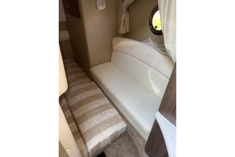 Slide: The Image of 2019 Rinker EX 320 boat spotlight and trailer on a sunny day. - 26