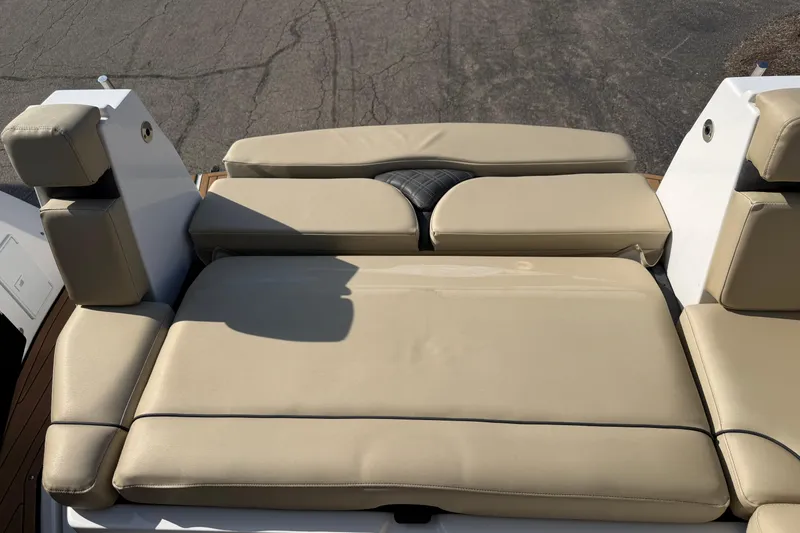 Slide: The Image of 2019 Rinker EX 320 boat with beige cushioned seating, outdoor setting. - 3
