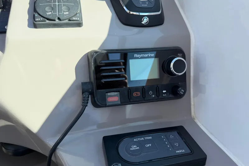 Slide: The Image of 2019 Rinker EX 320 boat cockpit with steering wheel and control panel. - 30